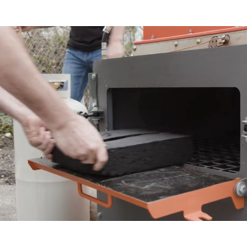 Hands loading asphalt bricks into the MR2X2 Mini Infrared Asphalt Recycler, Asphalt Bricks Full Pallet (63 bricks)