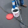 Using Crack Stix 1/4 inch black asphalt crack filler on pavement cracks with a torch for permanent repair'