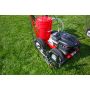 Newstripe 4250 line striping machine on grass, showing front spray gun and pump in outdoor application setting

'