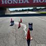 Top Patch Contractor Pavement Repair Kit used on a racetrack for asphalt crack repair, surrounded by cones under Honda bridge.

'