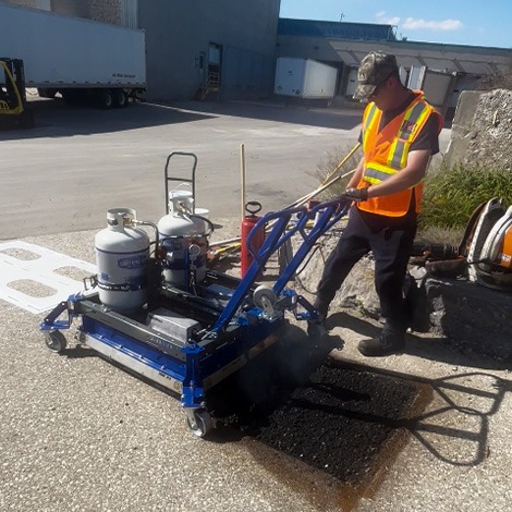 Contractor using infrared patching machine for asphalt repair